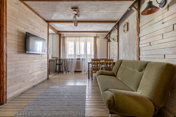 Bright Rustic Living Room with Green Sofa and Wooden Interior