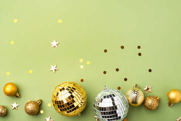 Festive Christmas gold ornaments on a green background.