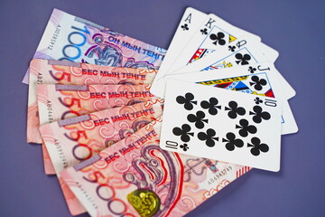 Banknotes of Kazakhstani tenge and gambling addiction. Gambling debts.