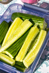Cucumber cut, cucumber sticks slices, green vegetable cuts for salad isolated, healthy natural plant pieces, macro cucumbers slicing on white background top view.