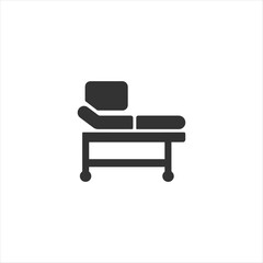 Black silhouette icon of a medical examination bed with wheels for patient assessment, hospital furniture, and clinical treatment.