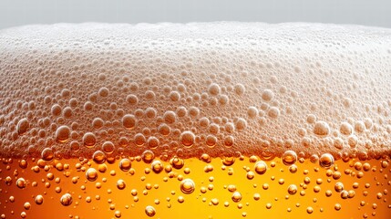 Close-up view of beer with bubbles and foam.
