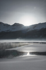 High mountain landscape with semi-frozen lake