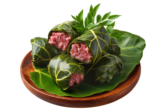 Lu Pulu corned beef cooked in coconut milk in taro leaves in wooden bowl, isolated on white transparent background, concept of traditional Polynesian food