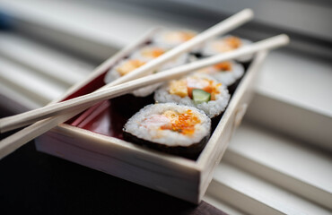 Chopsticks over sushi for lunch