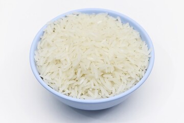 Uncooked jasmine rice in bowl white background