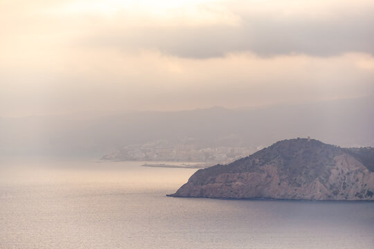 Sun-Kissed Coastline with Distant Town