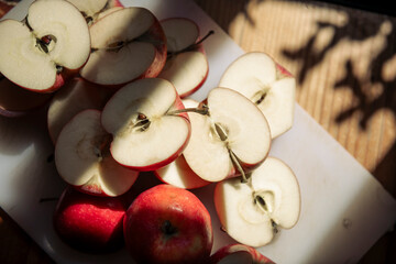 Autumn Harvest: Sliced Red Apples in Sunlight
