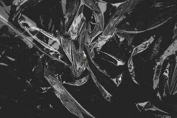 crumpled plastic wrap texture on black background
