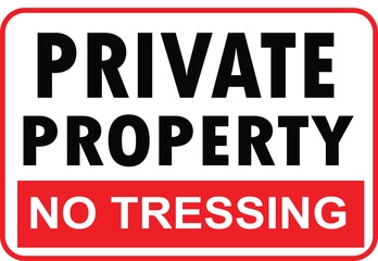 Fototapeta premium A rectangular warning sign with a red border and white background, displaying 'PRIVATE PROPERTY' in black text and 'NO TRESSING' in white text on a red strip.