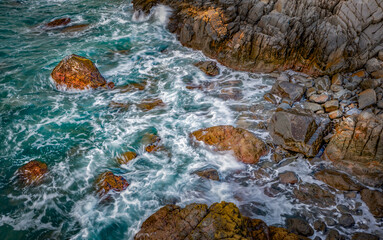 Fototapeta premium Vietnam Coastal Landscape, Ocean View in Vietnam, Waves Crashing on Mossy Rocks, Smooth Long Exposure Sea Waves, White Waves Hitting Rocky Shore, Vietnam Coastal Road