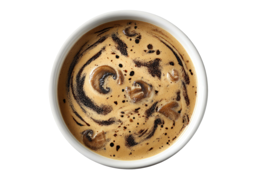 Creamy mushroom soup swirled with dark spices in a white bowl