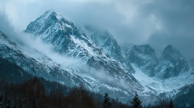 Snow covered mountain peaks shrouded in mist and clouds during daytime image - Powered by Adobe