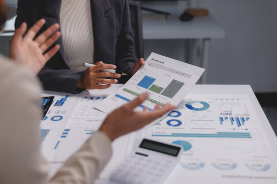 Business colleagues analyzing financial investment data charts - Powered by Adobe