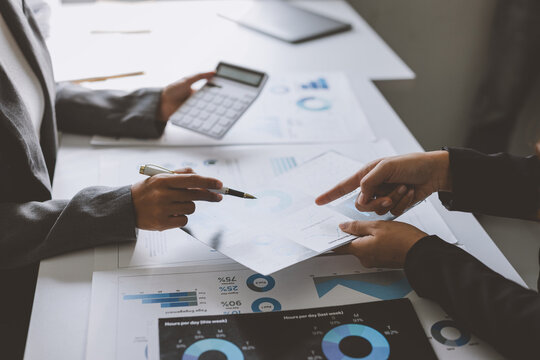 Business people collaborating on financial data analysis