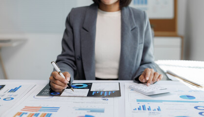 Businesswoman analyzing financial data and calculating budget