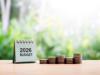 2026 desk calendar and stack of coins. The concept about budget planning and allocation in year 2026