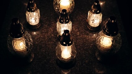 Votive Candle Lanterns on Surface of Limestone Grave Tombstone at All Saint Day Evening