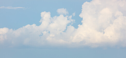 A cloudless blue sky with a few clouds