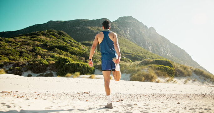 Man, fitness and stretching legs at beach with back for healthy muscle, circulation or training. Person, runner and warm up for flexibility, exercise and outdoor in summer with balance in morning