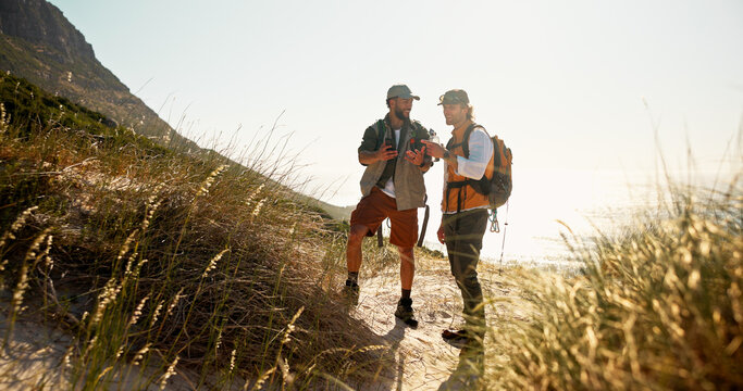 Conversation, hiking and phone with men outdoor together for adventure hobby or training. Exercise, fitness and talking with happy hiker friends on nature trail for backpacking or mobile directions