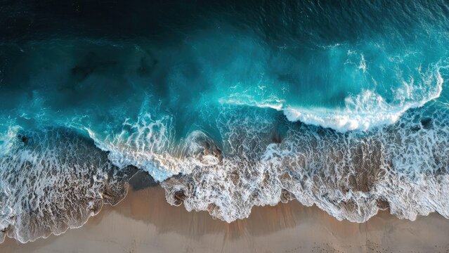 Aerial view of turquoise waves crashing onto a sandy beach. Concept Aerial Beach Photography, Turquoise Ocean Waves, Crashing Surf, Sandy Shoreline, Coastal Drone View