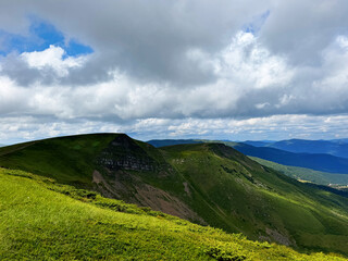 Amazing sunny landscape with pine tree highland forest at Carpathian mountains under blue sky.