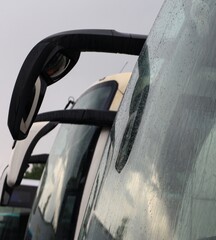 A line of buses in a bus park.