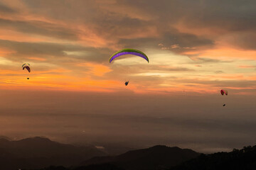 Paragliding over the clouds sunset view at Bir Billing Himachal Pradesh India. Clouds in the sky, Dhauladhar peaks view 5 pm 20 May 2025