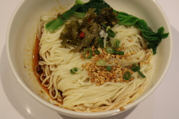 Bowl of Chinese Dan Dan Noodles with Greens