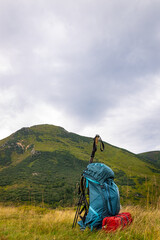 Summer hiking in the mountains with a backpack and a tent. Beautiful mountain landscape.