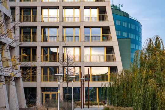 Modern architecture featuring repetitive balcony modules with yellow railings creating a distinctive geometric pattern across the building façade - Powered by Adobe
