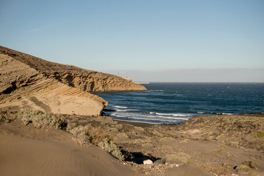 Dramatic cliffs and waves crashing against the shore in Tenerife, highlighting the rugged beauty of the islands coastline