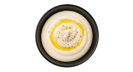Creamy white polenta with a swirl of golden olive oil and cracked black pepper in a dark bowl, isolated on a transparent background, cutout, PNG