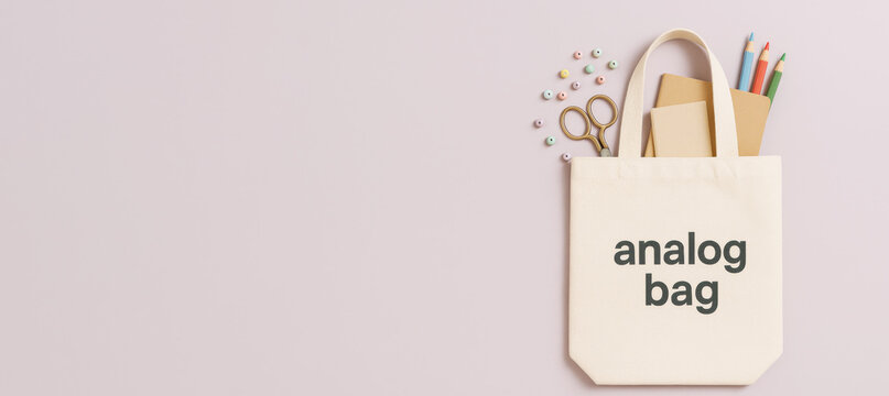 Tote bag with stationery and pastel background, featuring text analog bag