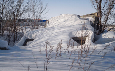 Concrete structure lies under the snow. Winter. Abstract