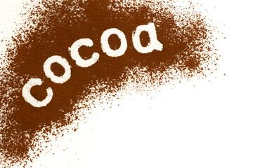 Cocoa word written on scattered cocoa powder background with copy space