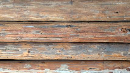 Obraz premium Close-up of weathered wooden logs with natural grain and texture, ideal for rustic or natural design themes.