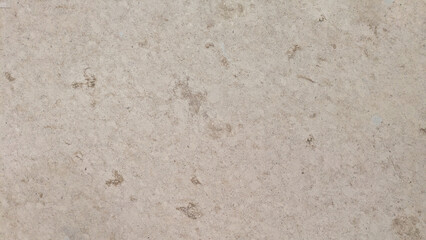A close-up view of a textured stone surface with natural variations in color and pattern.