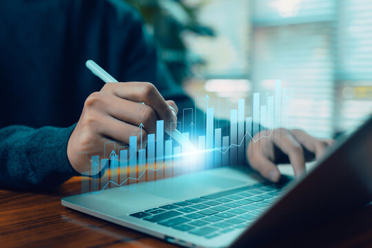 A hand using a digital pen to analyze a glowing rising bar chart on a laptop represents data analytics, financial growth, business performance, digital strategy, and modern technology-driven decision
