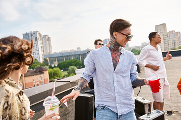 Young friends enjoy a vibrant party on the rooftop with drinks and laughter under the sun
