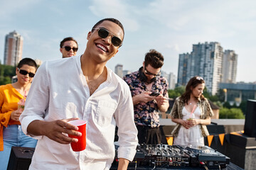 Young friends celebrate on a rooftop with music, laughter, and good vibes under the sun