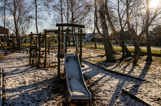 metal slide on wooden playground in early winter sunshine