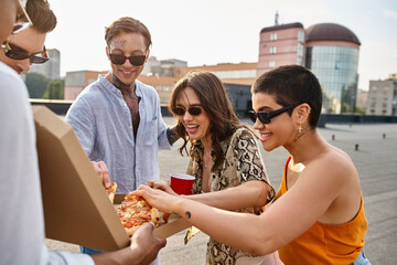 Friends enjoy a vibrant rooftop gathering with pizza and laughter during golden hour