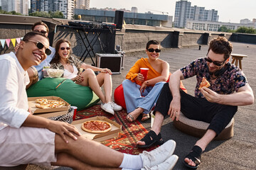 Friends enjoying a lively rooftop party with laughter and good food in the city skyline