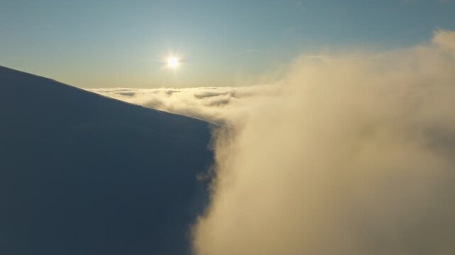 Peaceful mountain landscape illuminated by sunset with flowing clouds, Calm elevated terrain featuring luminous waterfall beneath drifting cinematic clouds during sunset