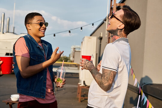 Young friends enjoying a vibrant party on the rooftop under the sunny sky - Powered by Adobe