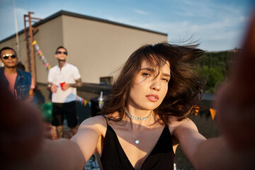 Young friends celebrate life together at an unforgettable rooftop party under the evening sky