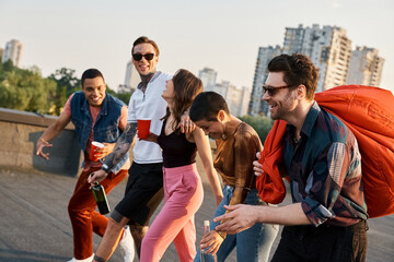 Fototapeta premium Young friends celebrating joyfully on a rooftop party in the city at sunset