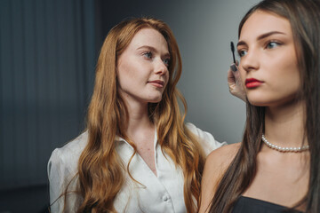 styling and photography in bright studio, artistic makeup and hair adjustment during fashion shoot